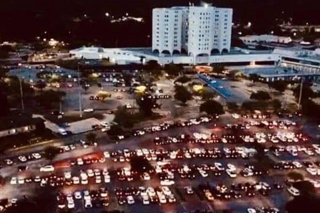 Parking lot full of cars with their headlights on at Providence Hospital