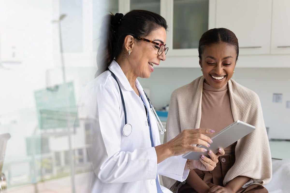 Woman getting care from doctor at Ascension Saint Agnes Hospital Cancer Institute.