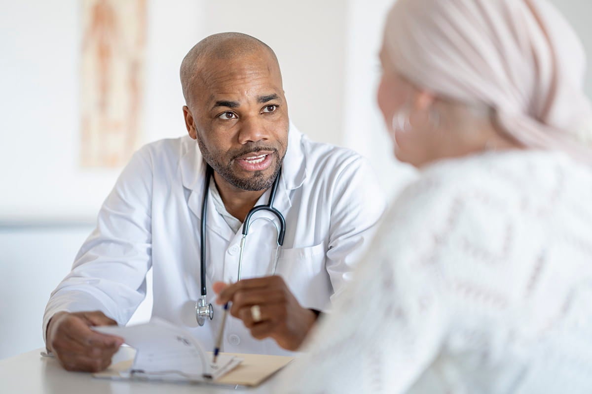 Doctor reviewing information with a patient during an office visit.