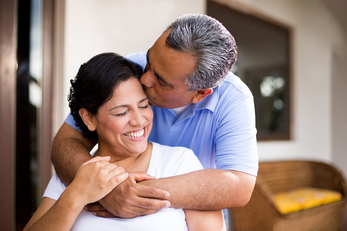 Husband and wife hugging.