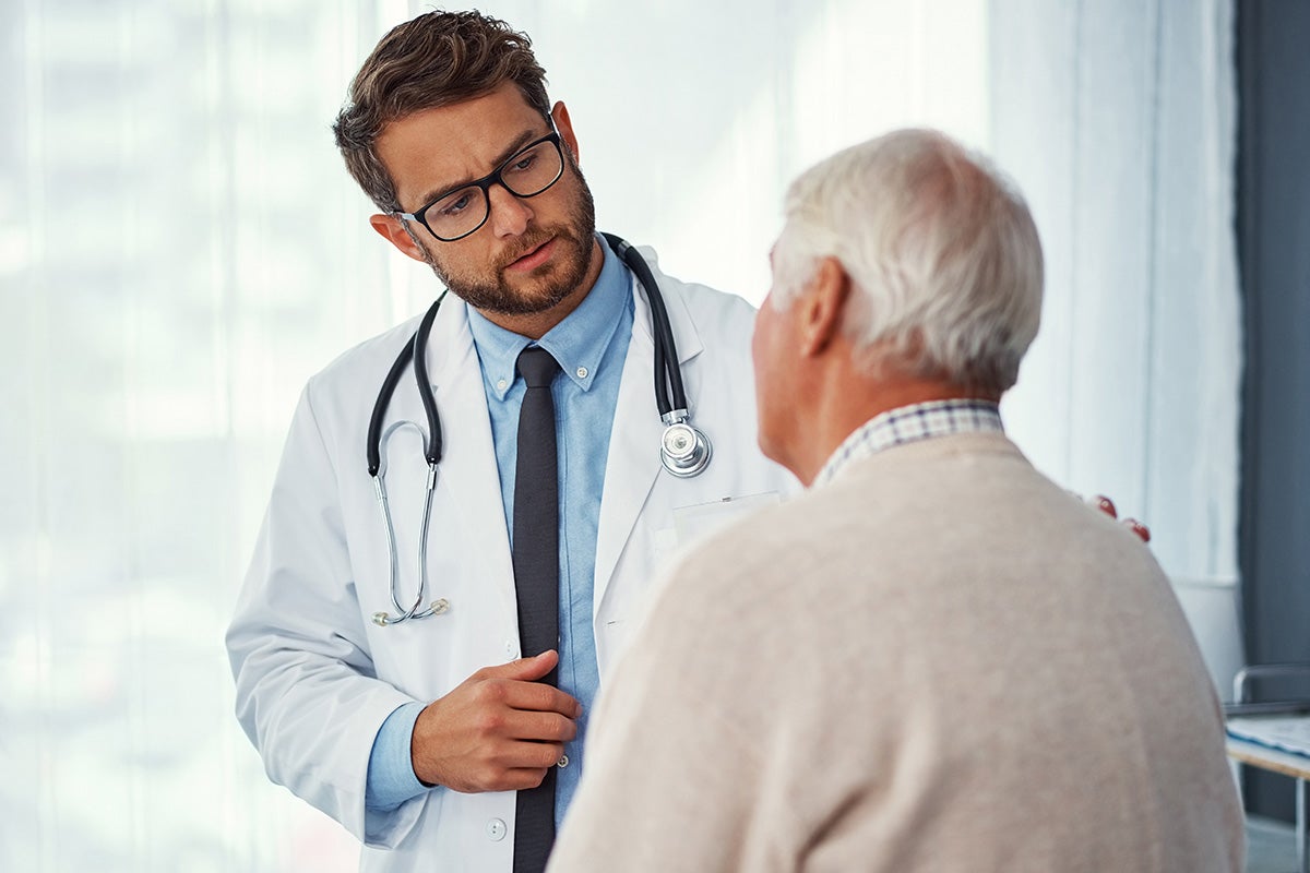 Man getting second opinion from doctor at Ascension Saint Agnes Hospital Cancer Institute.