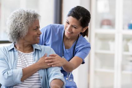 Female patient being comforted by her nurse before a procedure at Ascension Medical Group Seton Women's Health - Davis Lane in Austin, TX.