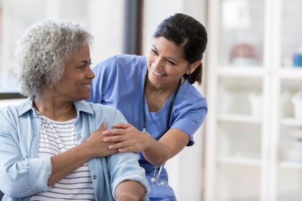 Patient at Ascension Alexian Brothers Rehabilitation Hospital in Elk Grove Village, IL, being supported by her rehabilitation nurse.