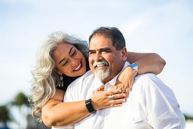 Middle aged couple hug: Specialists at Ascension Illinois help you achieve your weight-loss goals.