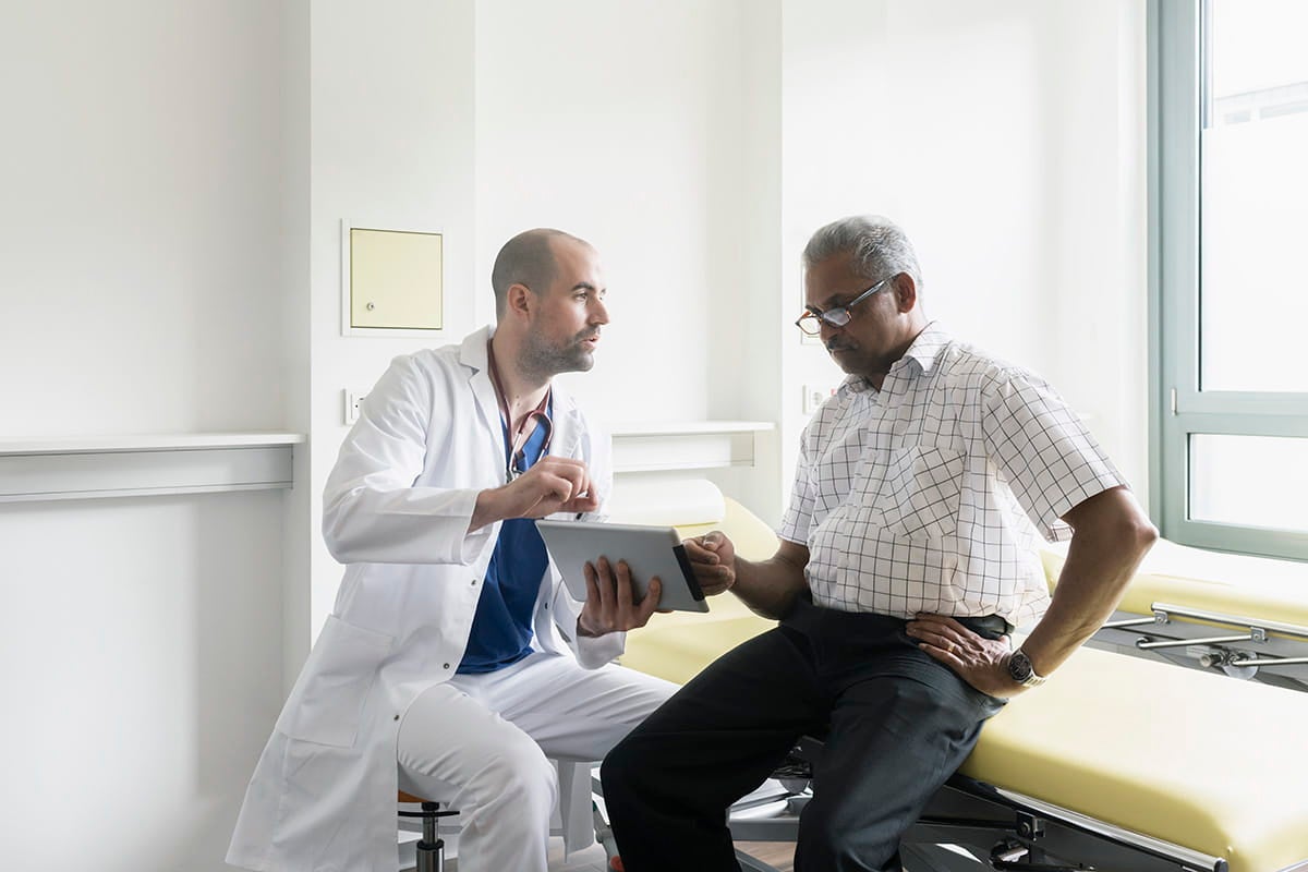 Neurologist talking with a male patient