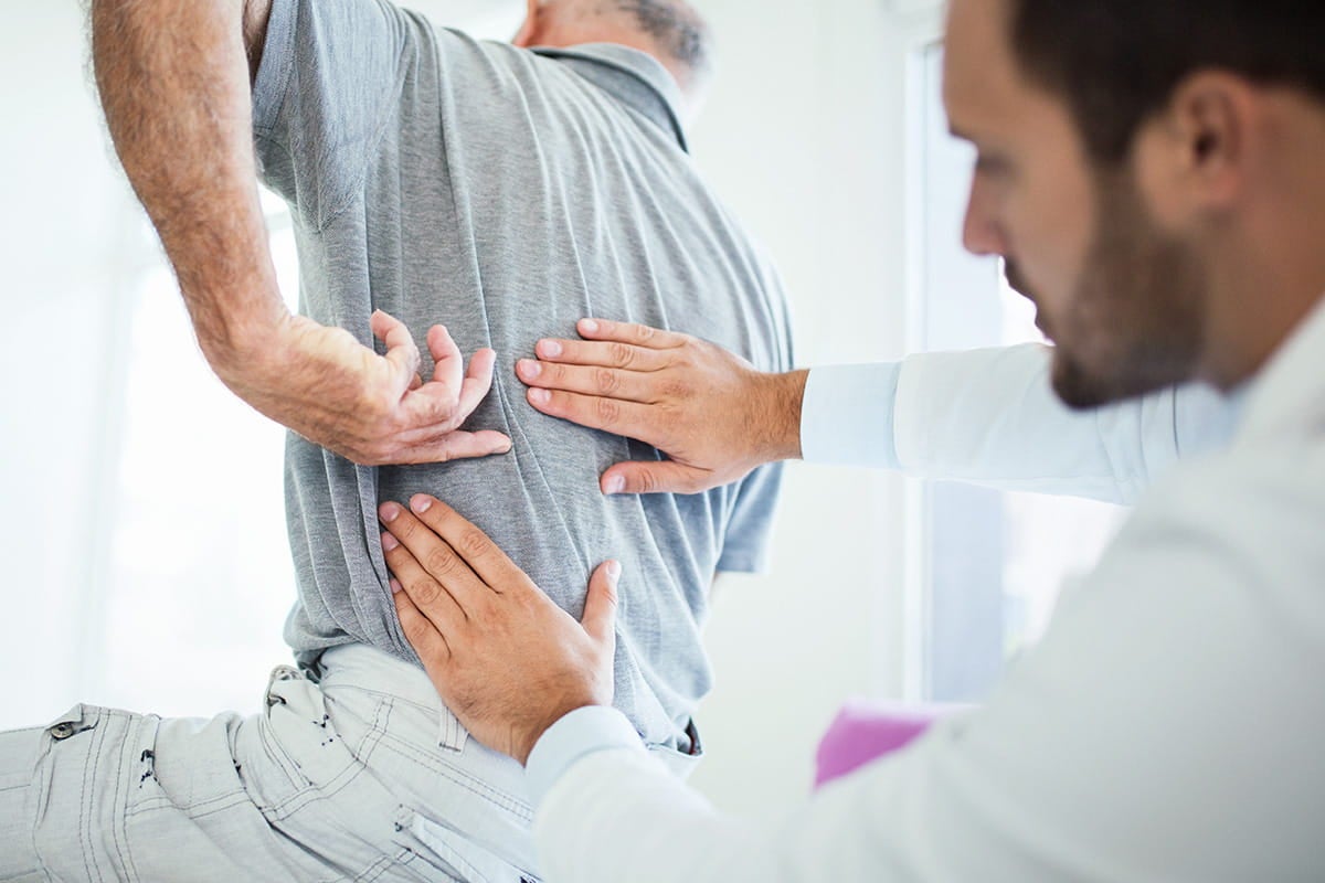 A man receives a consultation about his back pain from an Ascension Providence neurosurgeon.