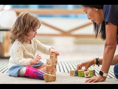 Little girl playing with blocks.