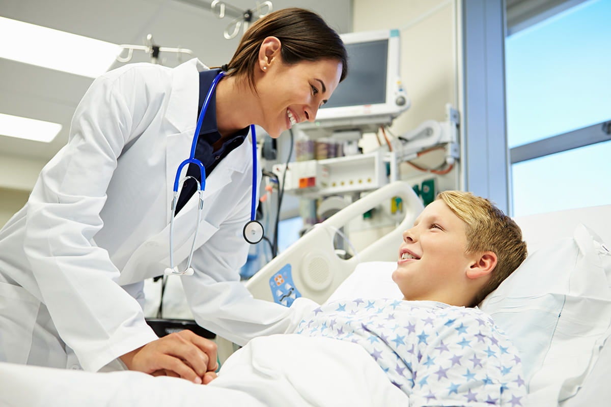 A doctor talking with a young male patient
