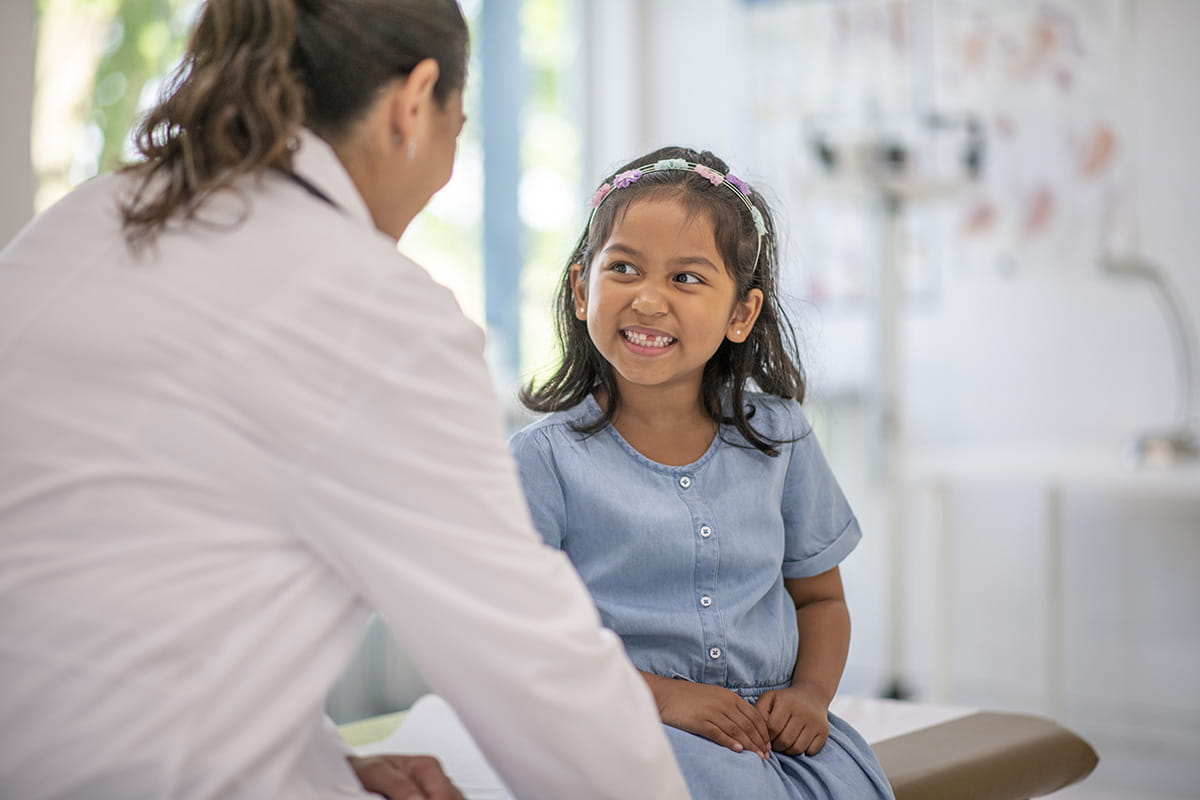 Child talking with a pediatric specialist at the Dell Children’s Colorectal and Pelvic Reconstruction Center  in Austin, Texas.