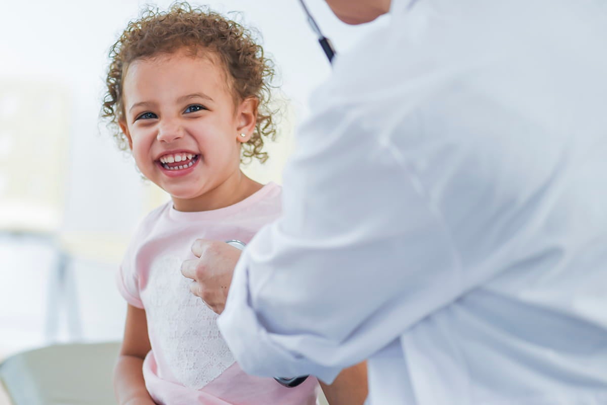 Child with sickle cell disease smiling.