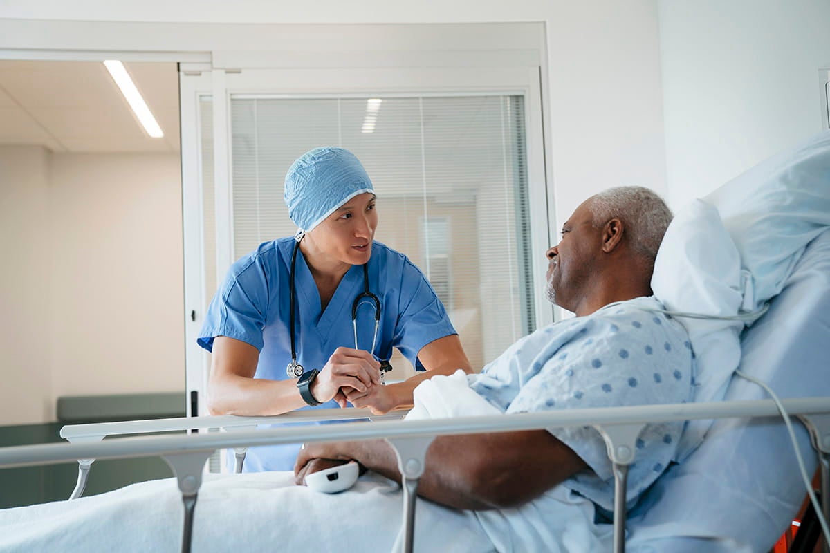 Doctor talking with man before surgery at Ascension Saint Agnes Hospital Cancer Institute.