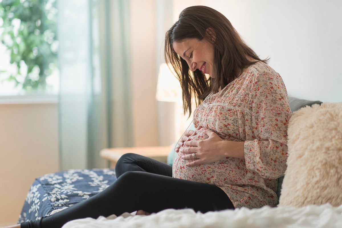 Pregnant woman sitting on a couch.