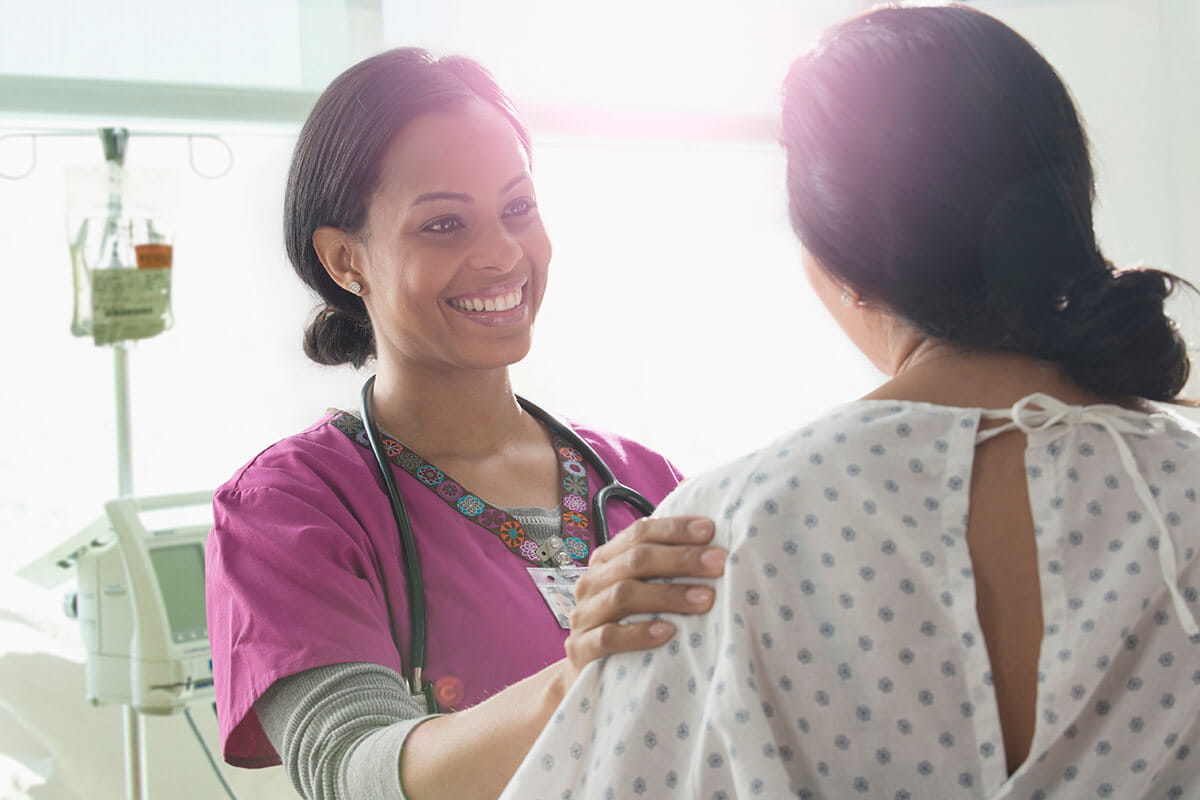 Breast cancer patient with a nurse at an Ascension site of care.