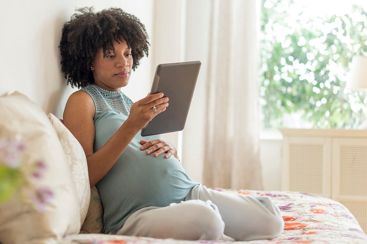 Pregnant woman on tablet