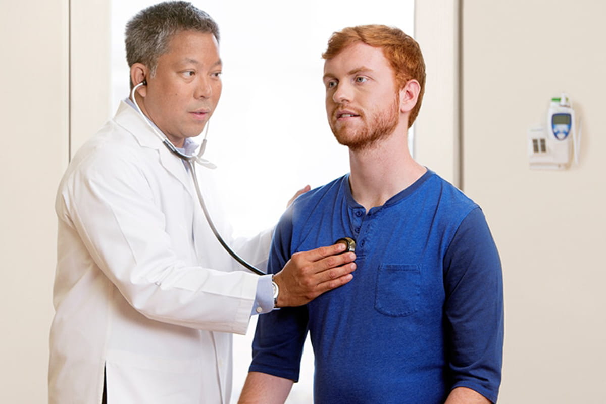 Doctor checking patients heartbeat