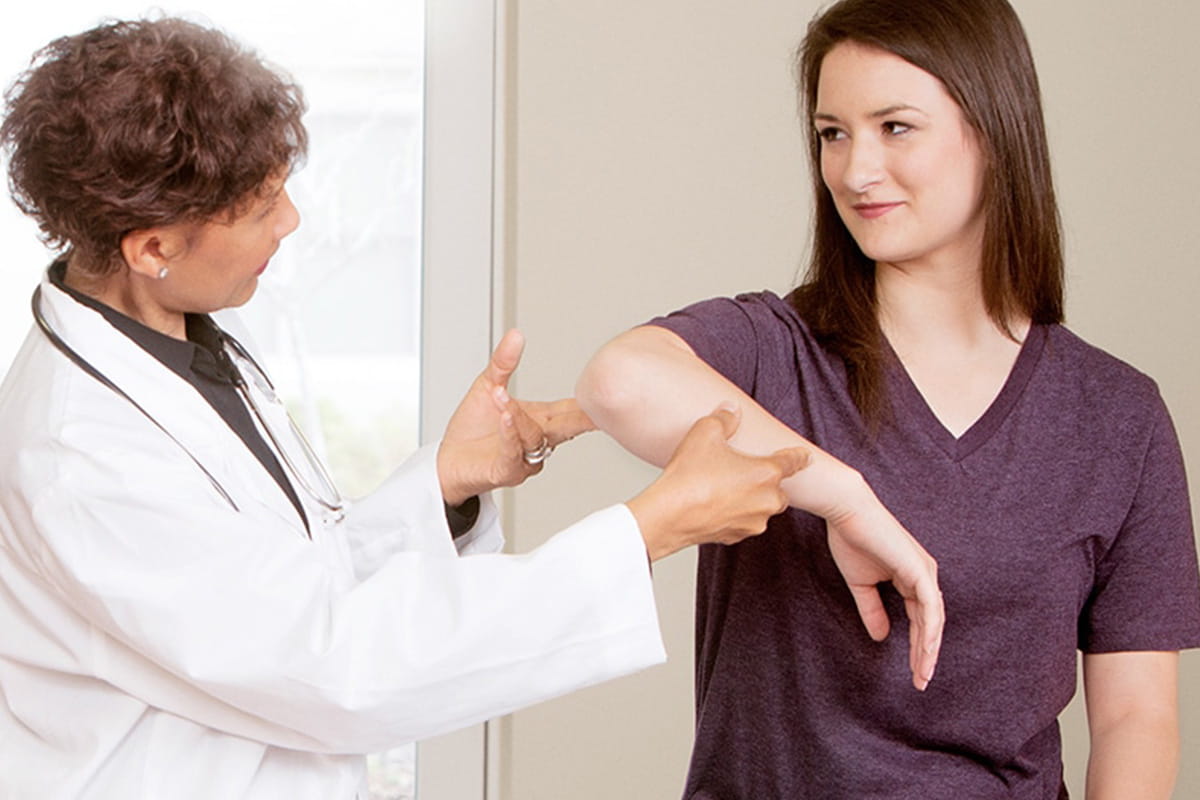 Doctor looking at a patient's arm 