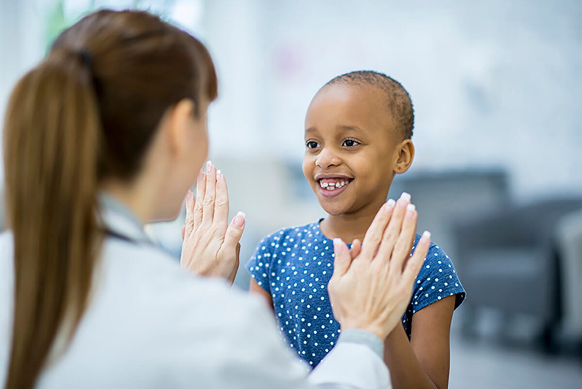 Child giving their doctor a high-five.
