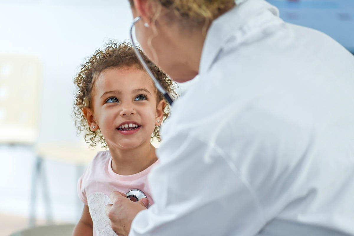Female doctor examining a child