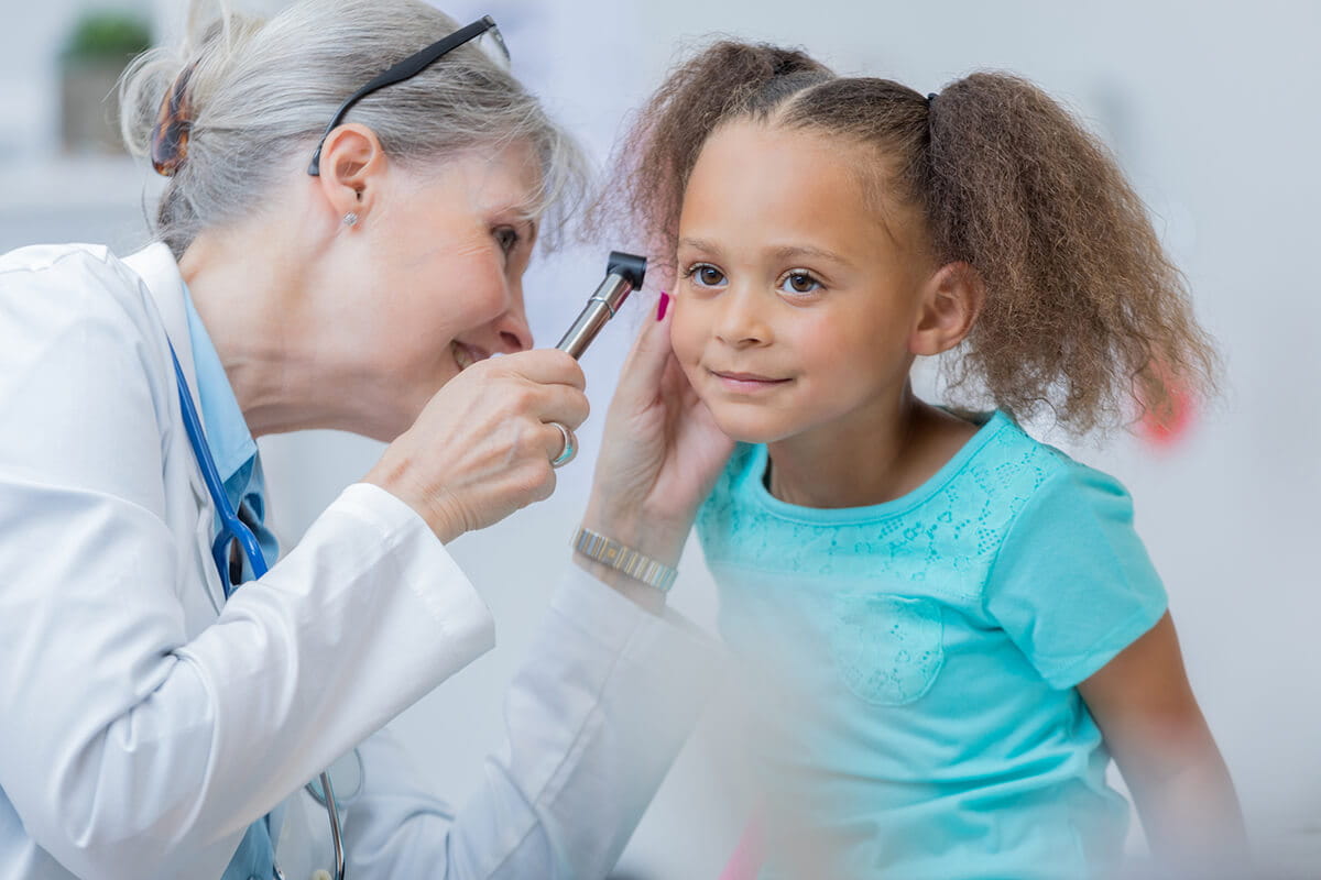 Doctor looking in child's ear.