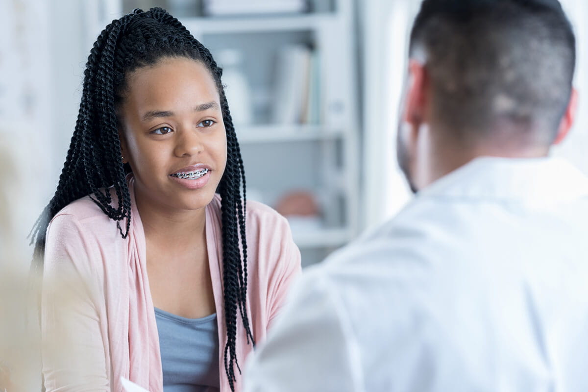 Teen girl talking with a mental health specialist.
