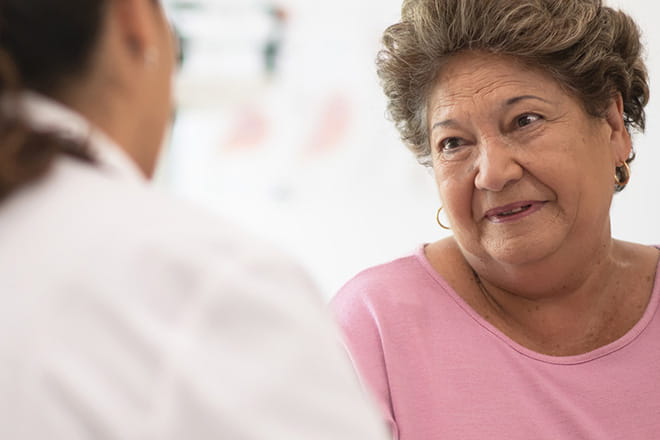 Woman talking with a cardiologist at an Ascension site of care.