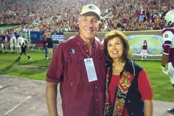 Coach George Henshaw at a Florida State football game with his wife