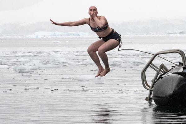 Breast Cancer Survivor Colleen Ochab of Wheeling, IL, dives into the Southern Ocean around Antarctica