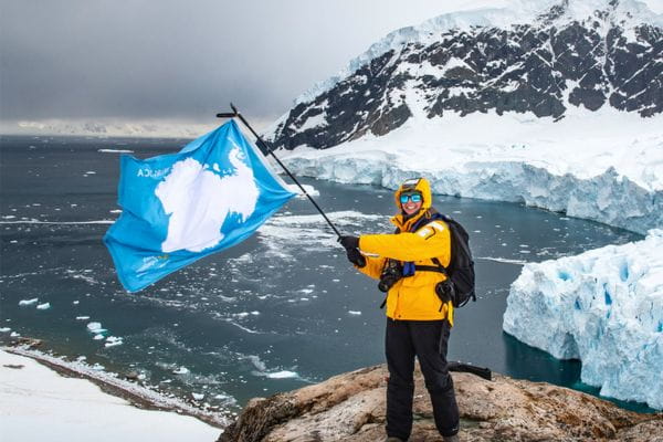 Breast Cancer Survivor Colleen Ochab of Wheeling, IL, waving the Antarctic flag in Antarctica