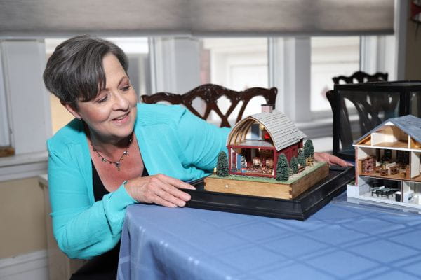 Chicago breast cancer survivor Karen Wilson shows off the miniature-style bungalow and Cape Cod cottage she built during chemotherapy.