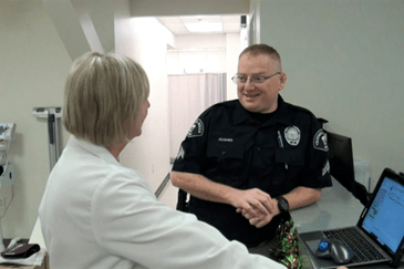 Officer Jerry Hughes talks with his provider at Ascension St. Vincent’s Occupational Health Services in Vestavia Hills, AL.