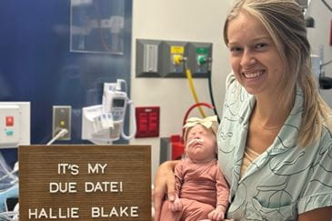 ER nurse holds her baby that was delivered in the Sacred Heart NICU 