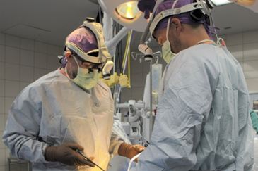 Dr. William Clark and Jason Gates P.A. performing spinal surgery