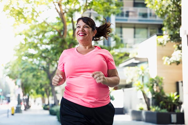 A woman jogging in the street.