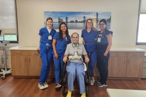 Mr. Santorelli sits with his rehabilitation care team