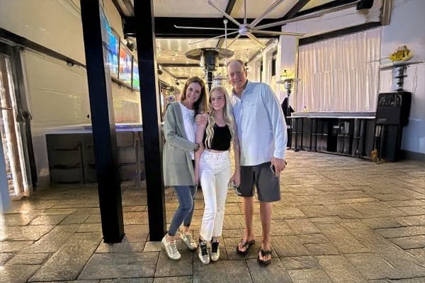 Santa Rosa Beach resident Dee Dee stands at a restaurant with her husband and daughter