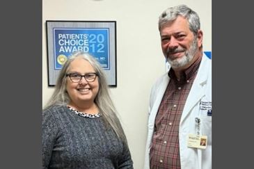 Dr. Eugene Dabezies, an orthopedic surgeon with Ascension Sacred Heart Orthopedics poses with Laura, one of his patients