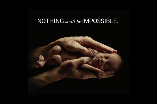 Nothing shall be impossible. Hands holding a baby.