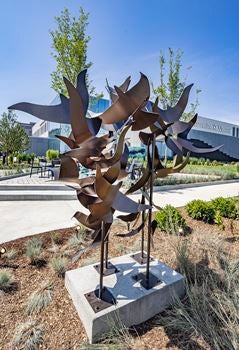 A sculpture sits in a garden outside the Lucas Family brain and spine hospital