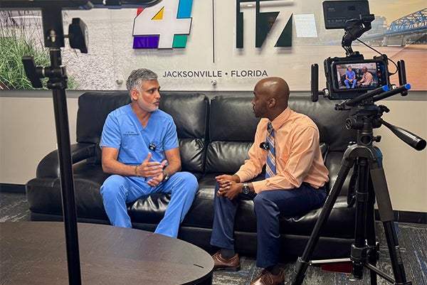 Dr. Saumil Oza, cardiologist at Ascension St. Vincent’s Riverside in Jacksonville is being interviewed by a news reporter.