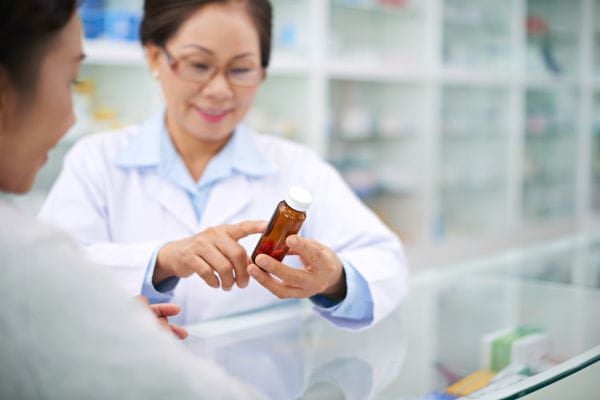 Pharmacist showing a patient a perception bottle