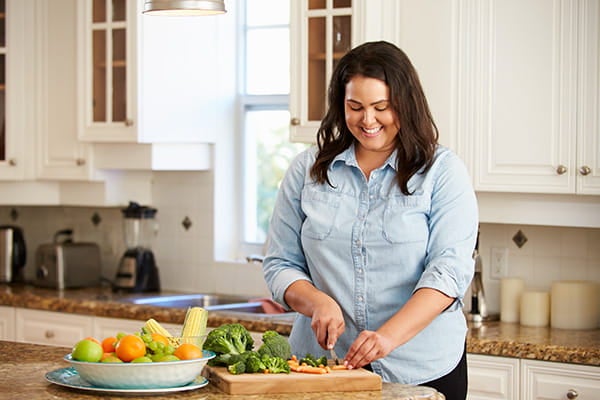 Woman cutting vegetables in the kitchen