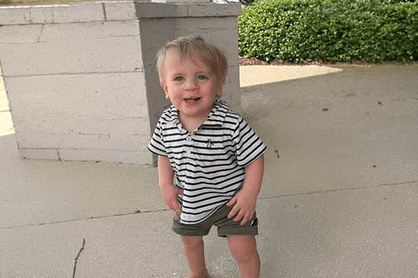 Elijah smiles brightly while celebrating progress in his craniofacial care journey at Studer Family Children’s Hospital.