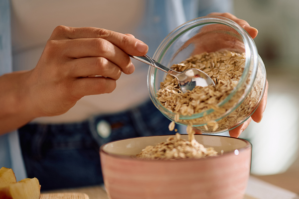 Preparing a bowl of oats for fiber.