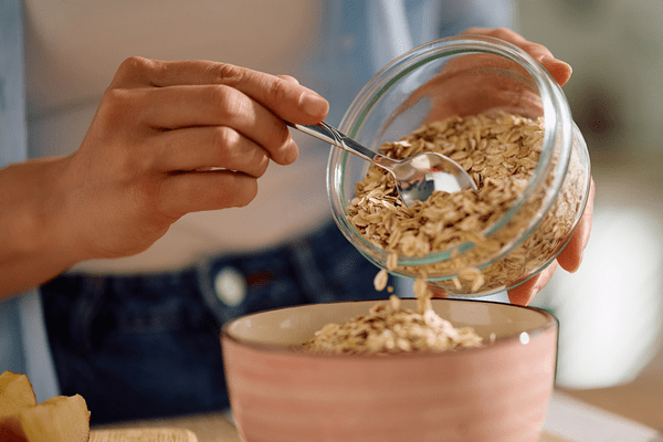 Preparing a bowl of oats for fiber.