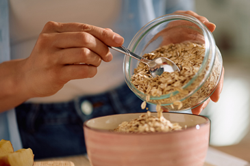 Preparing a bowl of oats for fiber.