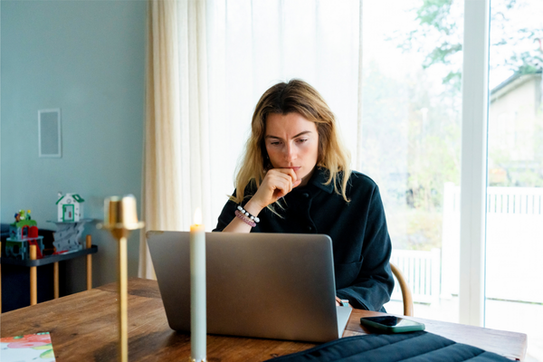 Woman on her laptop looking over her health insurance benefits