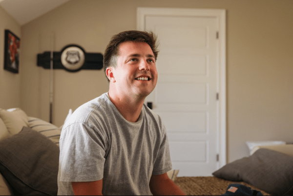 Ben sitting on a sofa at his family home in Georgia.
