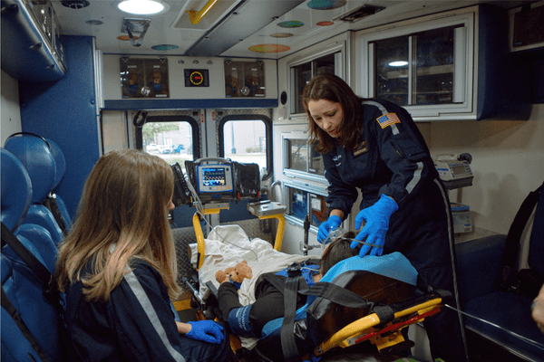 Dell Children's Transport Team cares for a patient inside a critical care transport ambulance.