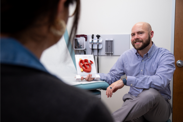 Dr. Joshua Davis explains AFib heart rhythm tracing to a patient.