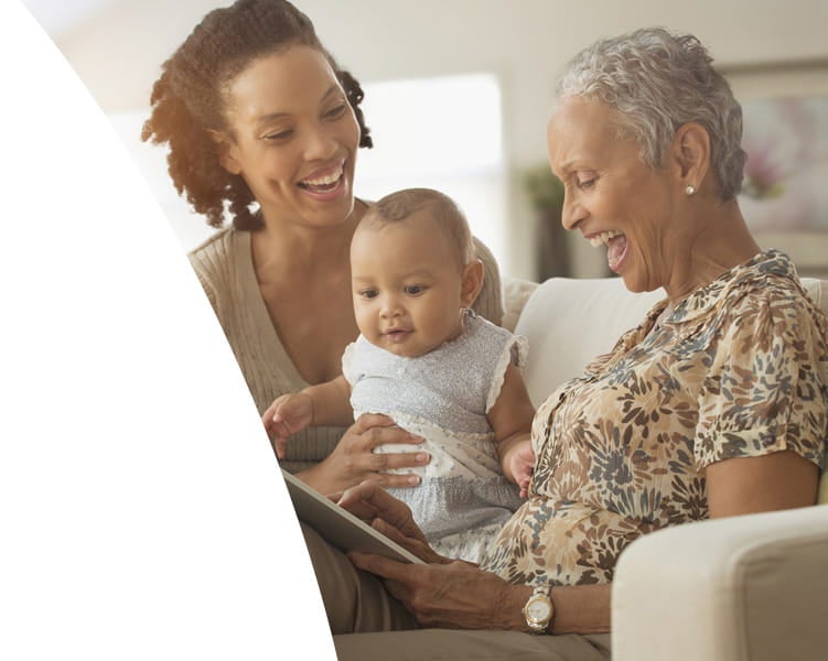 Grandma, mother, and daughter sitting on the sofa